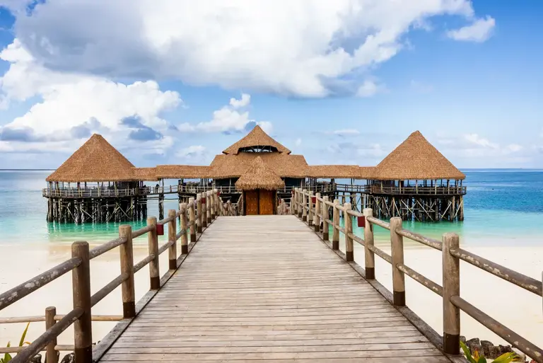Wooden walkway leading to a beach resort in Zanzibar