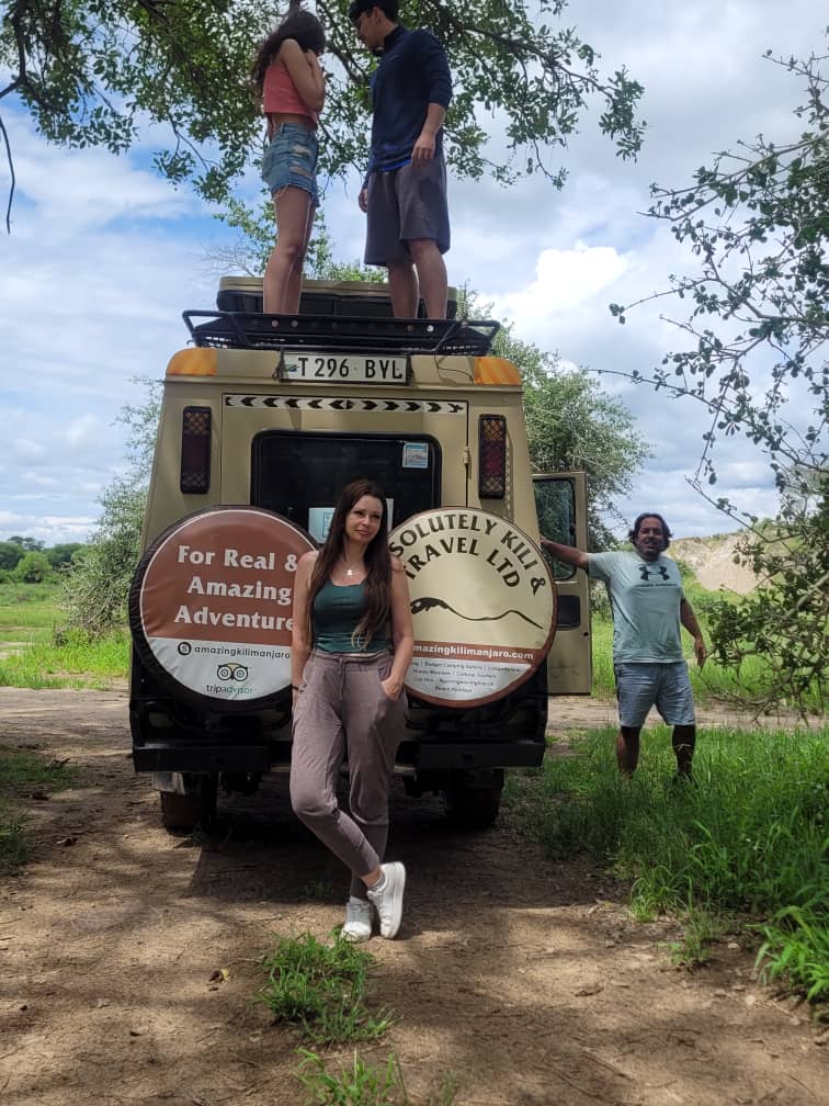 Absolutely Kili & Travel safari vehicle parked on a bush track in Tanzania