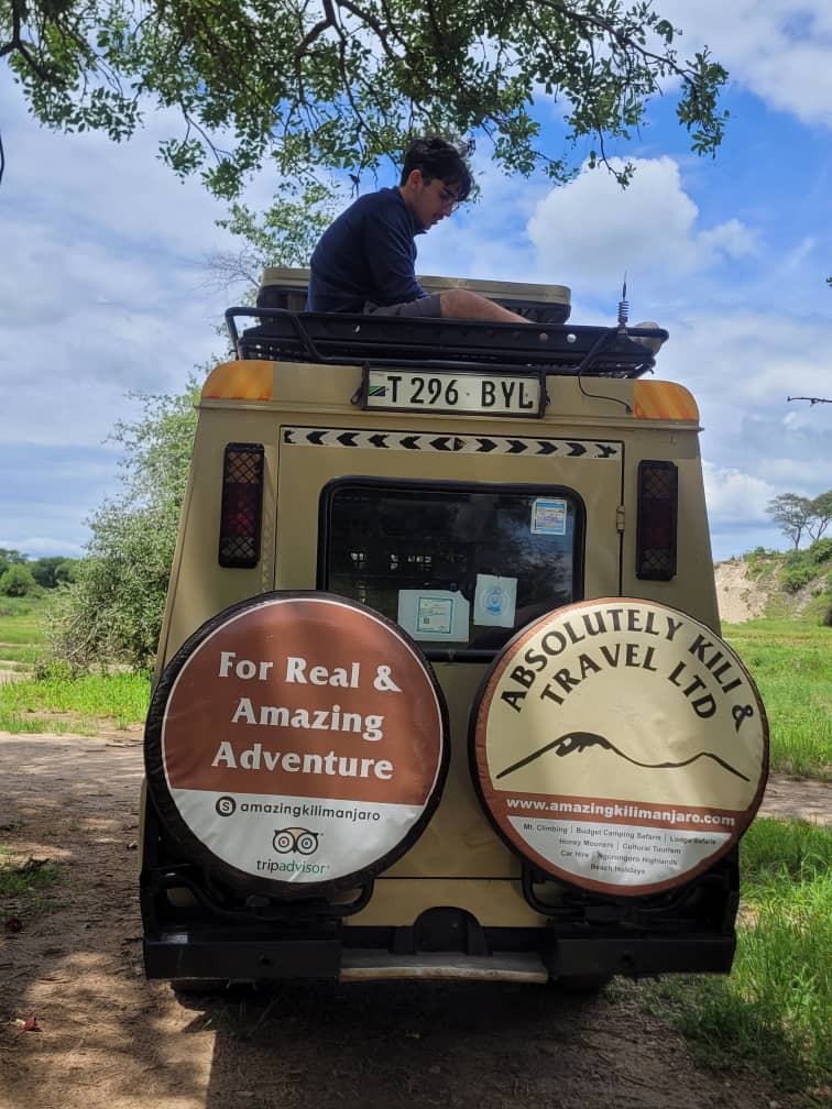 Close view of the Absolutely Kili & Travel Ltd branding on the safari vehicle spare wheel covers